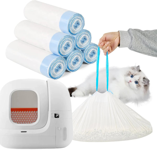Extra thick blue drawstring litter bags stacked next to a white automatic litter box and a cat