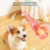 A dog is playing with a pink squeaky tennis ball toy while being kept entertained.