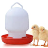 White automatic poultry feeder and waterer with a red tray, shown next to two yellow chicks.