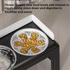 A black elevated dog feeder with two stainless steel bowls filled with yellow kibble.