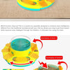 A yellow puzzle toy for dogs with a clear bowl and various food elements.