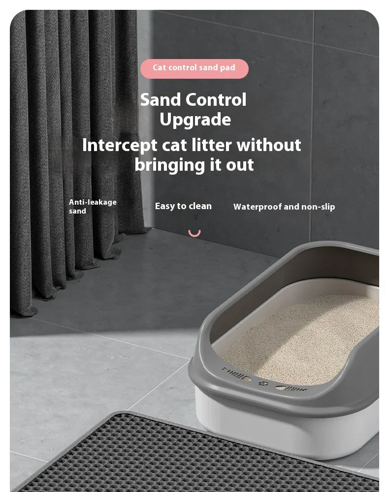 A close-up view of a gray cat control sand pad and litter box with a non-slip mat.
