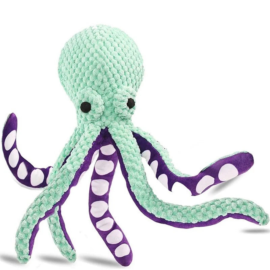Weiches grünes Plüschoctopusspielzeug mit lila Akzenten und Polka Dots.