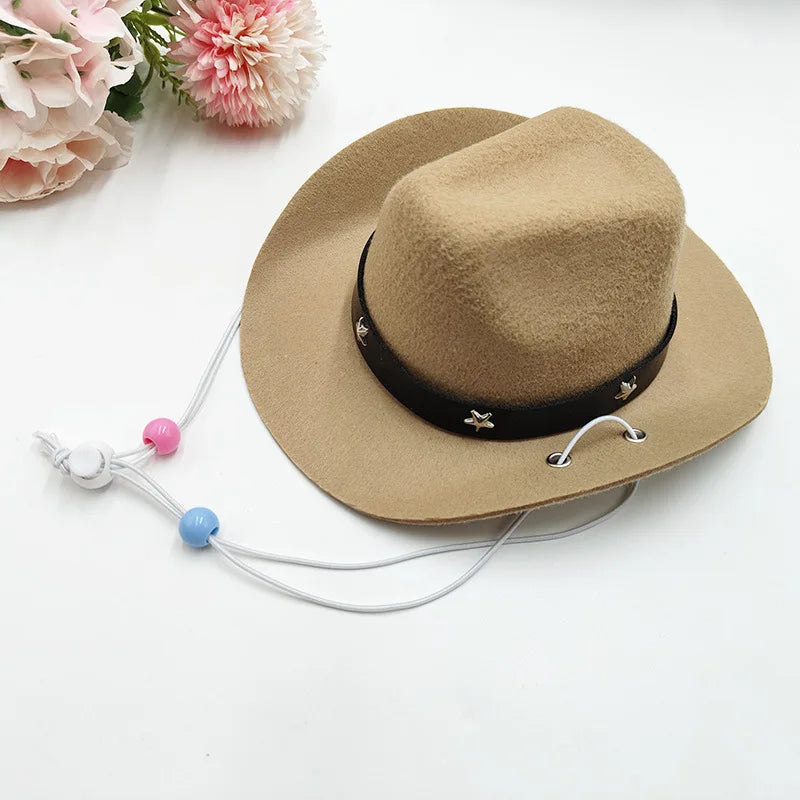 A beige felt cowboy hat with a black band and white leather cord, resting on a white surface.