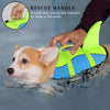 A hand is using a rescue handle on a neon yellow and blue dog life jacket for rescuing a dog in the water.