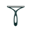 A close-up view of a green pet hair remover and fabric shaver tool.