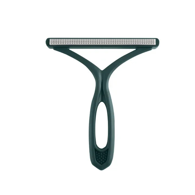 A close-up view of a green pet hair remover and fabric shaver tool.