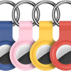 A silicone airtag protective cover in various colors, including blue, pink, yellow, and red, shown with a keychain ring.