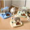 A white cat is standing next to a 2-in-1 automatic pet feeder with separate compartments for water and dry food.