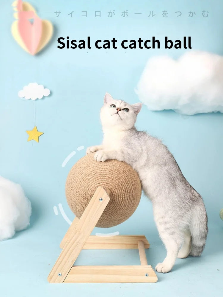 A fluffy gray cat is interacting with a sisal cat catch ball toy resting on a wooden base.