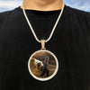 A silver chain necklace features a round pendant with a photograph of a person in winter clothing.