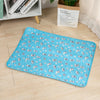 A light blue pet training mat with a repeating pattern of small gray cats on a wooden floor.