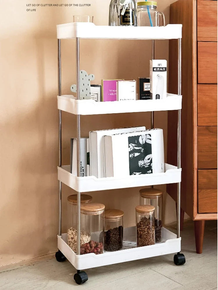 A white mobile storage rack with three tiers holding various small items and jars.