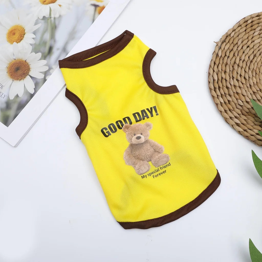 Yellow pet vest with brown trim featuring the text Good Day and a teddy bear illustration.