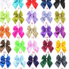 A collection of twenty-five colorful satin bow ties in various shades including pink, purple, green, yellow, and black for pe