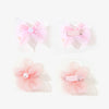 Two pink pet hair bow clips and two pink flower-shaped clips for grooming accessories.