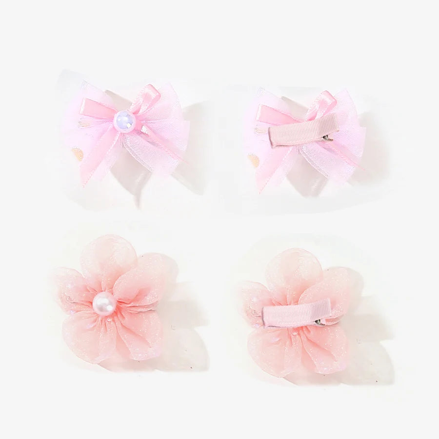 Two pink pet hair bow clips and two pink flower-shaped clips for grooming accessories.