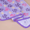 A purple fleece blanket featuring a pattern of pink, yellow, and purple paw prints.