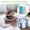 A cat is sitting on a rug next to a stainless steel water fountain and replacement filter components.