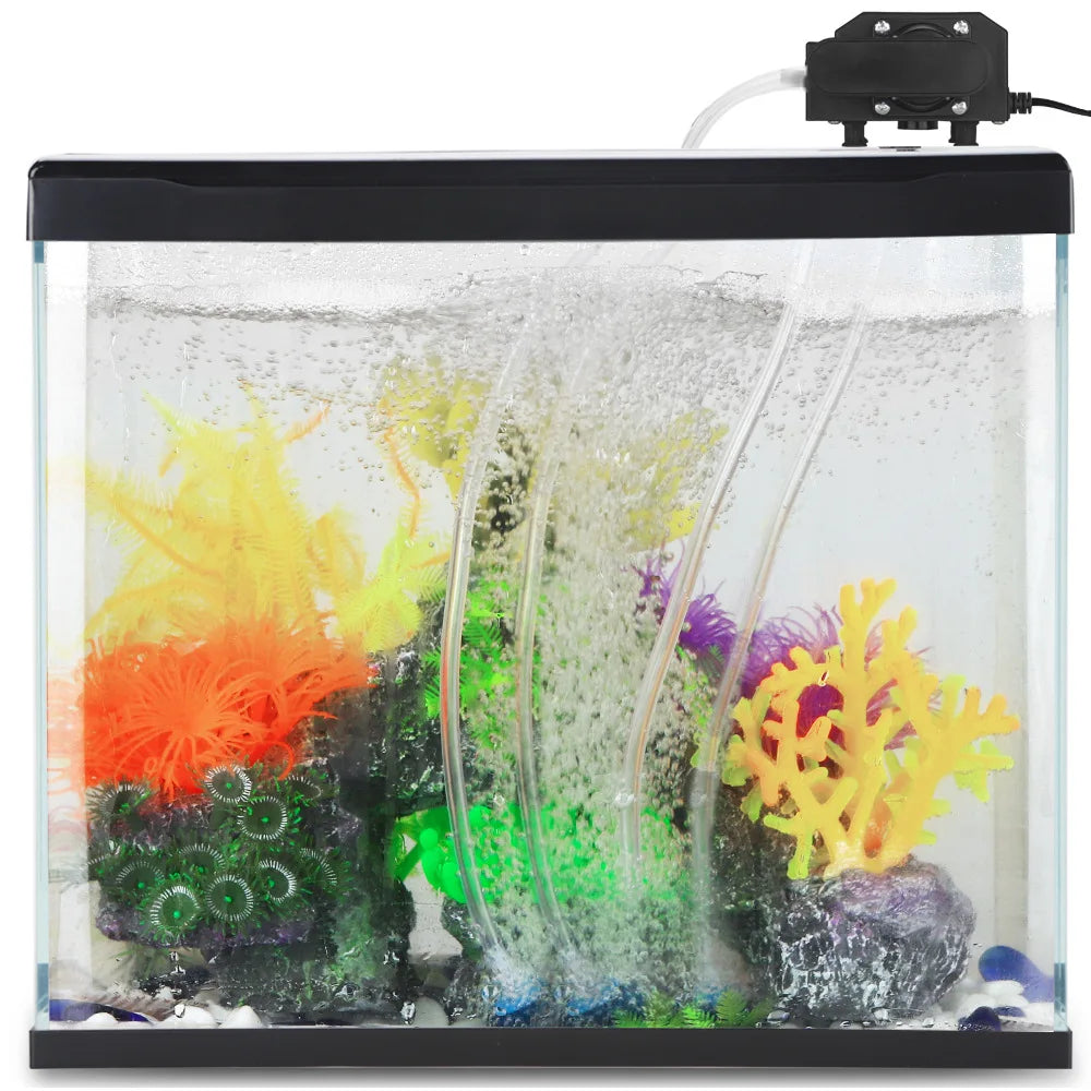 A clear aquarium tank filled with water and colorful aquatic plants, featuring an air pump setup.