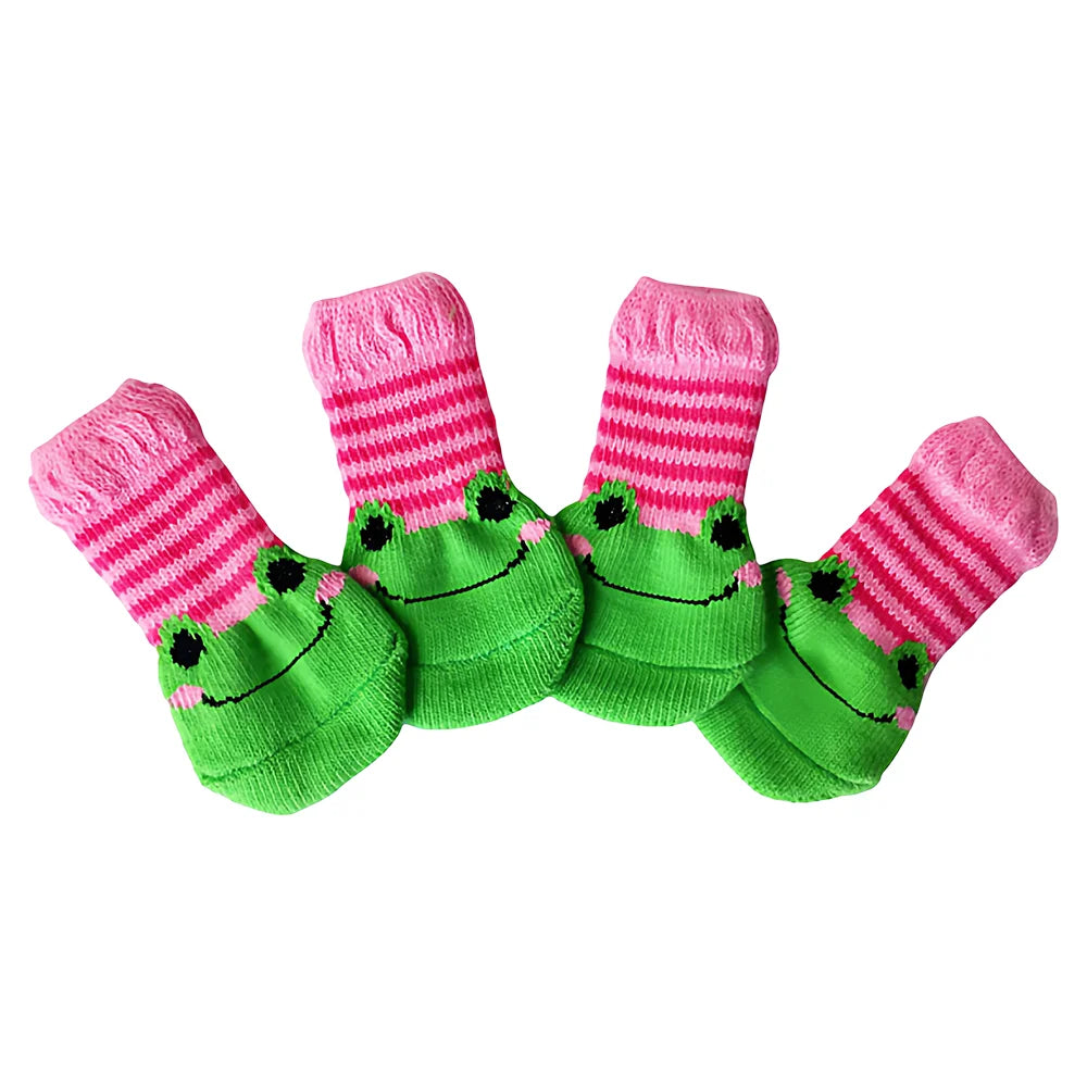 A pack of four pink and green striped anti-scratch cotton pet socks shaped like smiling frogs for small dogs and cats.