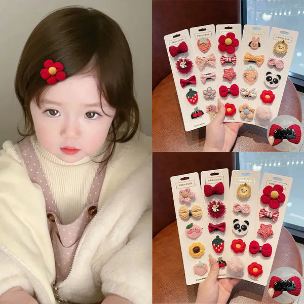 A collection of five adorable flower-shaped baby hair clips in various colors and patterns displayed on a card.