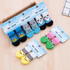 Pack of pet socks featuring cute dog and cat designs in various colors like black, blue, and pink.
