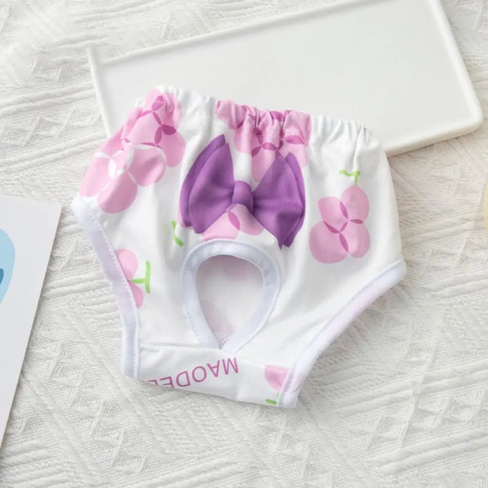 White reusable dog physiological pants with pink floral patterns and a purple bow