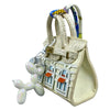 Handcrafted mini house-shaped bag in cream leather with a puppy keychain charm