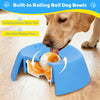 A dog is using a blue silicone rolling ball bowl slow feeder to eat food.
