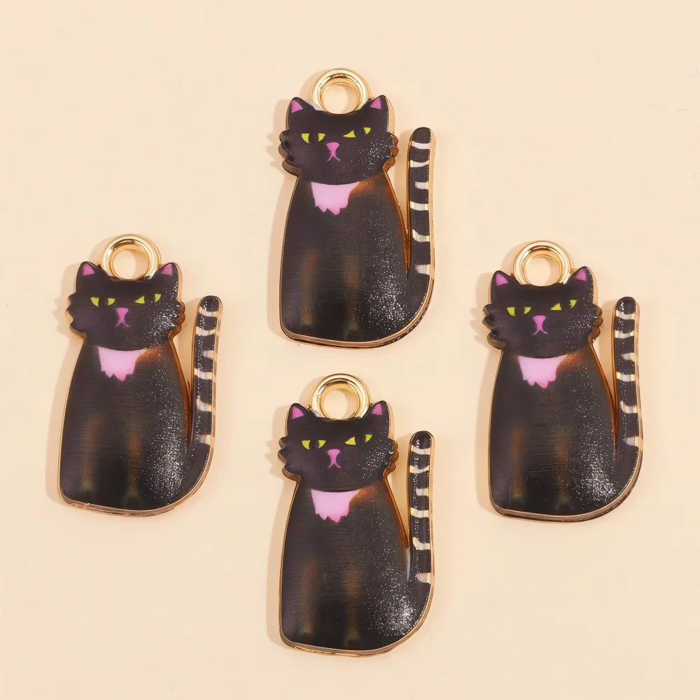 A set of four dark cat pendant charms with glitter and purple accents for jewelry making