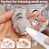 A hand is using a white LED pet hair trimmer to trim small areas like paws, ears, and eyes on a cat.