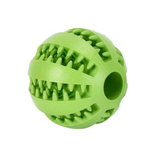A bright lime green rubber ball with spikes used as an interactive treat dispenser for dogs.