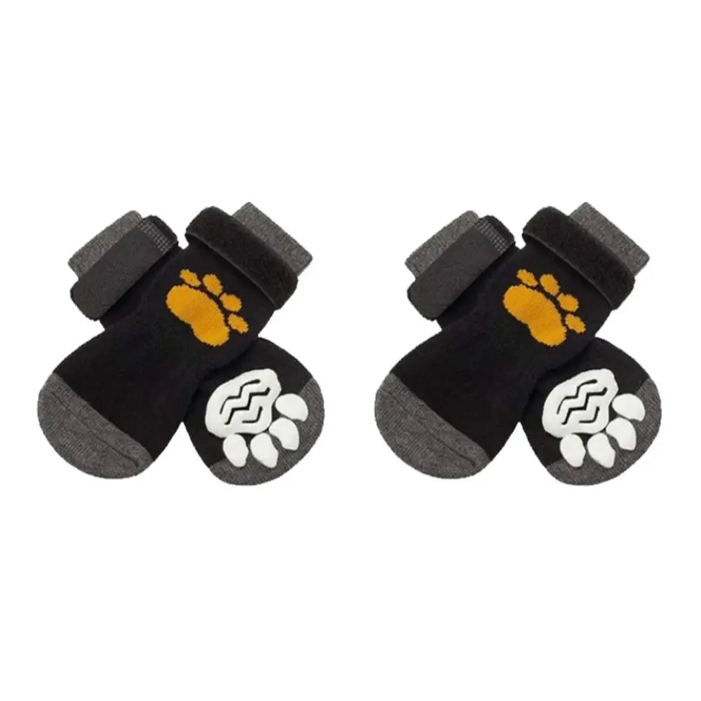 Pair of black anti-slip dog socks featuring yellow and white paw prints