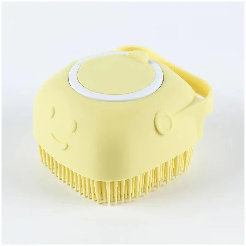 A yellow silicone pet bathing massage glove with a white circular nozzle and a bristled surface.