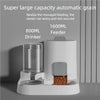 A white automatic grain feeder and water drinker unit with a transparent tank and a feeding compartment.