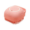 A pink silicone pet bath massage brush with foam maker head.