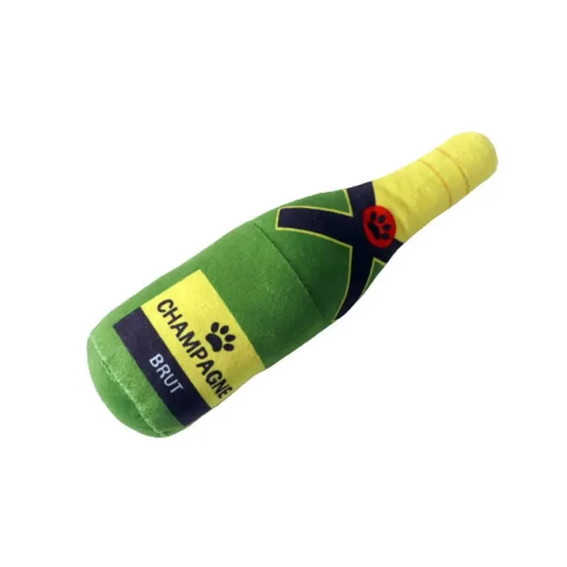 Green plush beer bottle dog toy with a yellow tip and a black paw print design.
