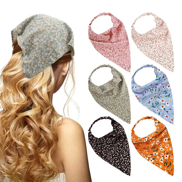 A woman shows off various floral paisley triangle head scarves in pink, green, blue, and orange colors.