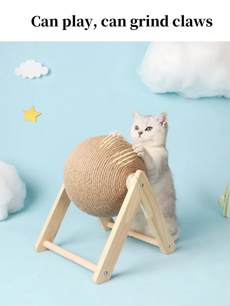 A fluffy gray cat is playing with a round sisal rope ball toy supported by a wooden base.