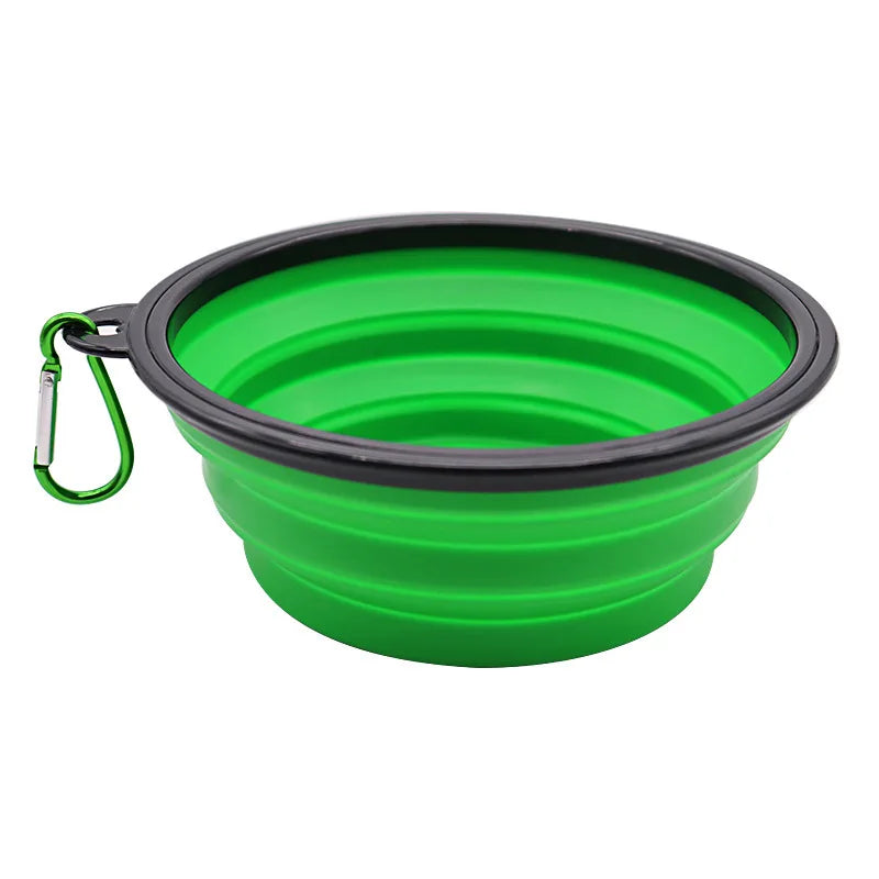 A bright green silicone pet feeder bowl with a black rim and a metal carabiner attached.