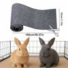 A roll of self-adhesive cat scratch pad material next to two gray and tan rabbits.