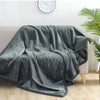 A soft gray microfiber blanket draped over a sofa, suitable for pets or couples.