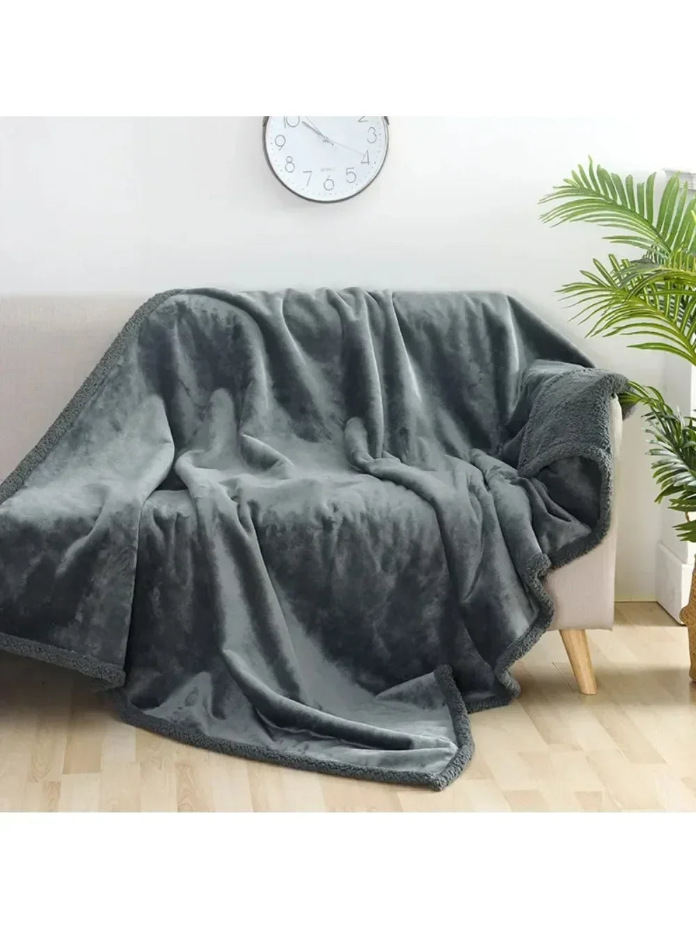 A soft gray microfiber blanket draped over a sofa, suitable for pets or couples.