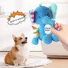 A hand holds a blue plush elephant toy with a vocal area, next to a small dog.