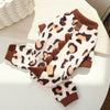 A cozy fleece dog hoodie with animal ears in a leopard print pattern, resting on a light-colored surface.