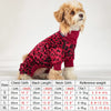 A small, light-colored dog wearing a red leopard print pajama top and matching bottoms.