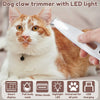 A cat is being groomed with a white and orange LED light dog claw trimmer.