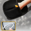 A black double-sided pet grooming glove is shown being used for hair removal on a hand.