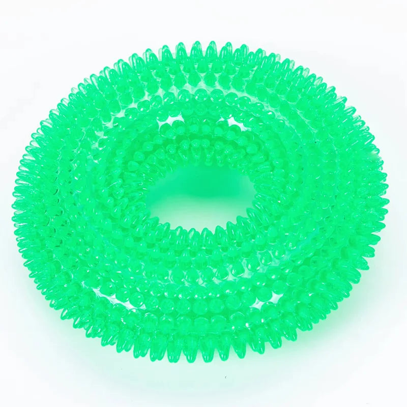 A bright green spiky squeaky dog chew toy for dental care